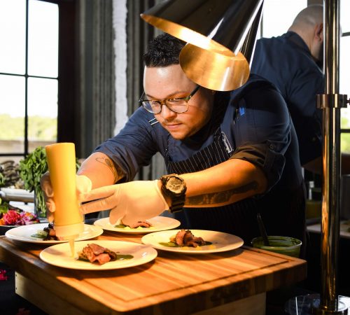 Chef garnishing plates of food